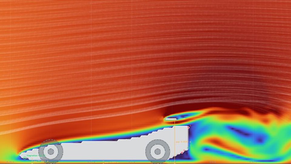 The STEM Racing car preset in the WindCanvas tunnel: smoke flowing over the body and rear wing, with a swirling wake behind